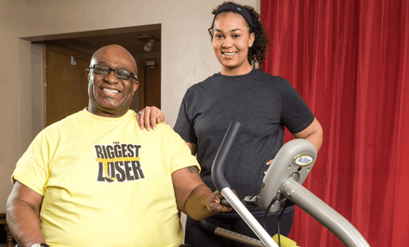 O'Neal-Hampton-and-daughter-sunshine-smiling-next-to-nustep
