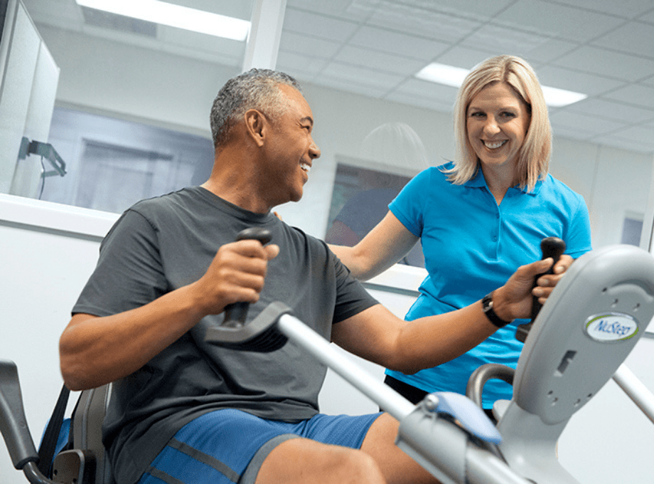 middle-aged-man-and-woman-physical-therapist-cardiac-rehab-programs-nustep-cross-trainers