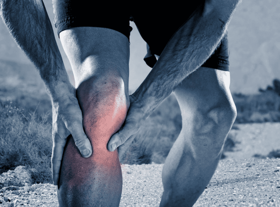 man_running_stopped_holding_knee_pain